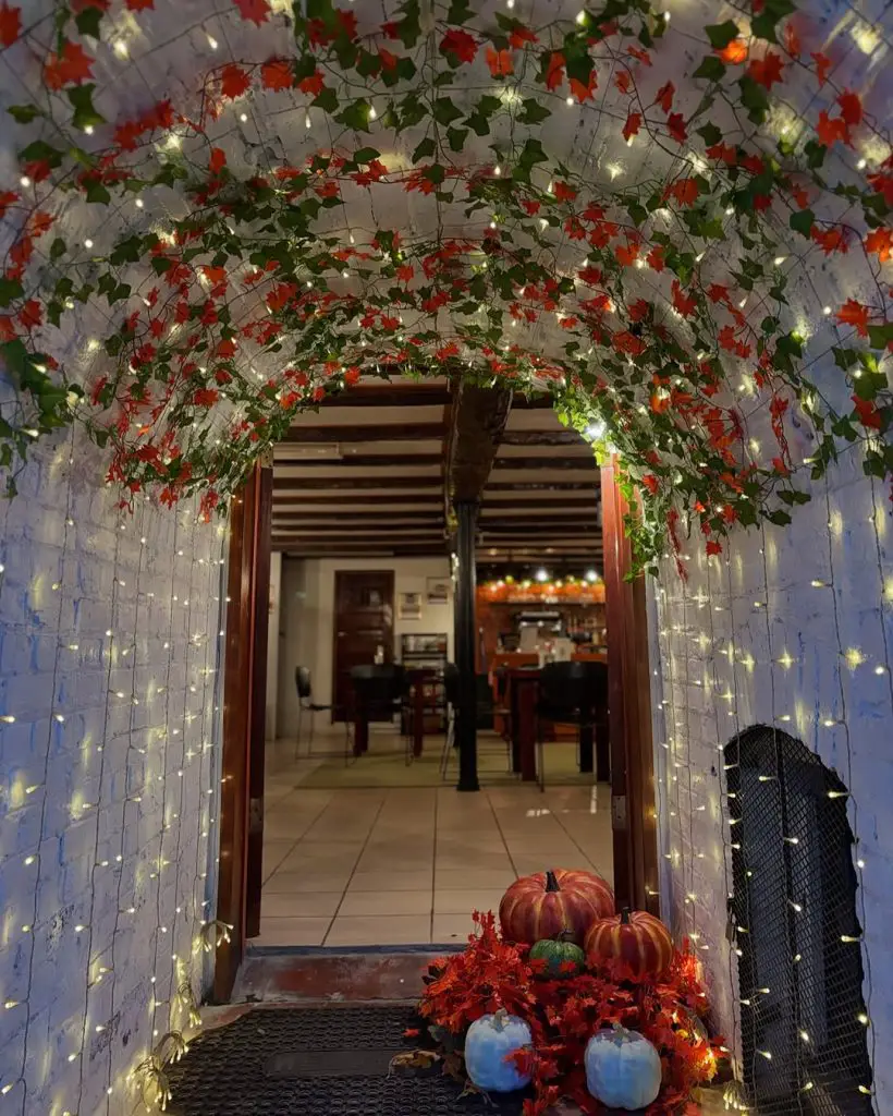 Festive entryway with lights and pumpkins