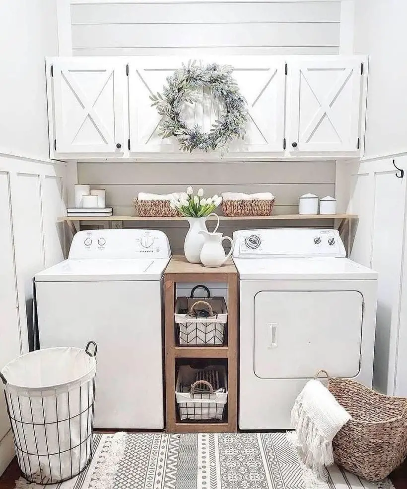 White farmhouse laundry room with wreath and floral decor