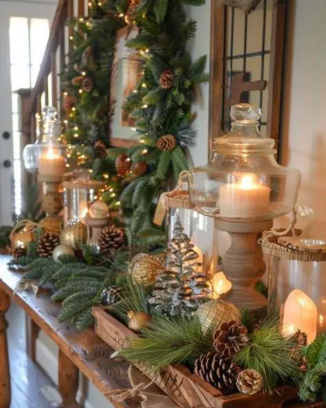 Festive console table decorated with greenery, candles, and ornaments