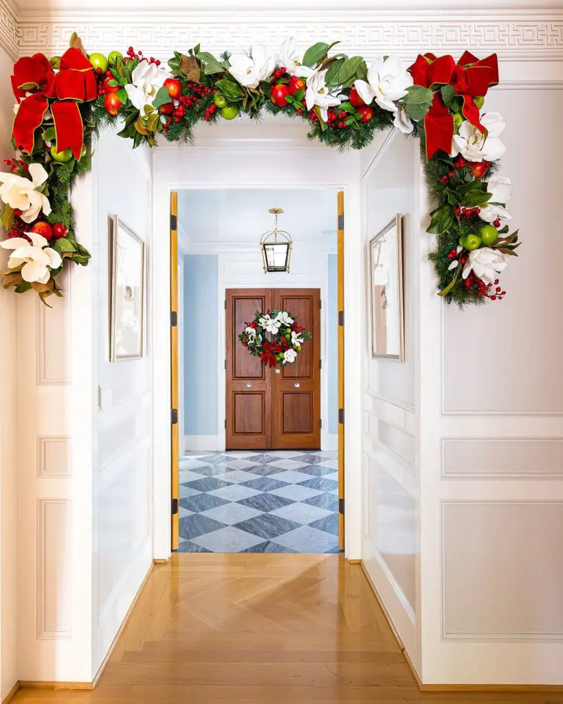 Elegant entrance decorated with garlands and wreath.