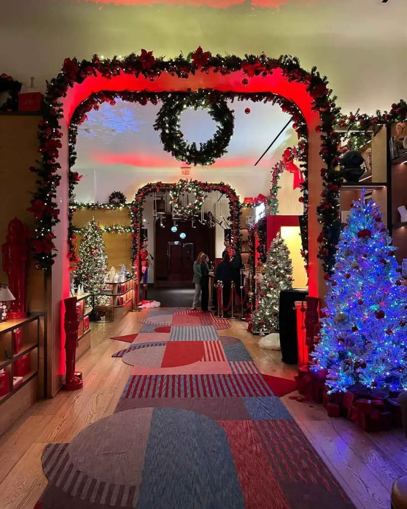 Festive hallway decorated with Christmas trees and colorful lights