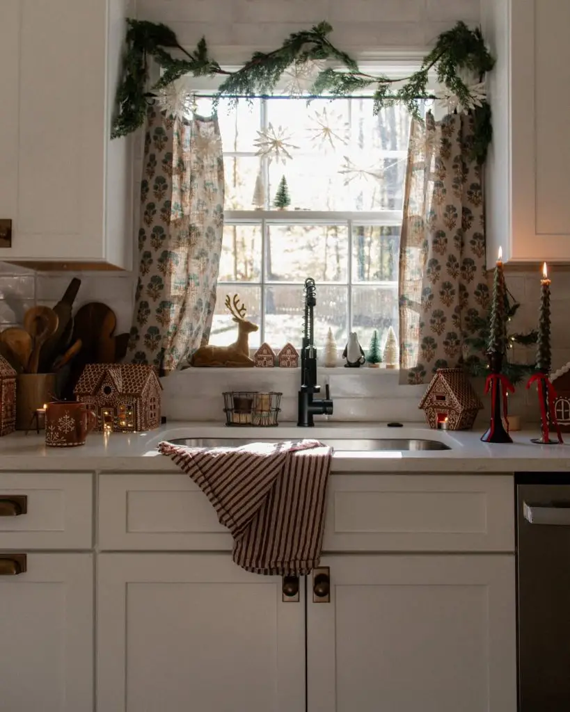 Festive winter kitchen with farmhouse sink and holiday decorations.