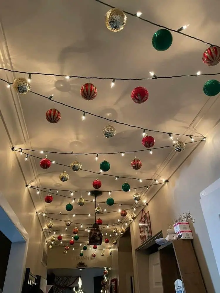 Hallway decorated with hanging ornaments and string lights for Christmas