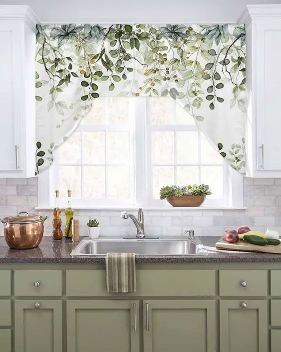 Fresh kitchen with farmhouse sink, botanical curtain, and green cabinetry