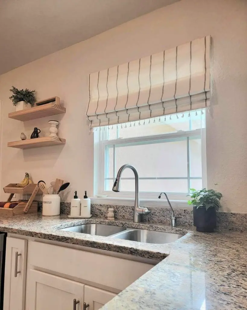 Charming farmhouse kitchen with marble countertops and floral valance