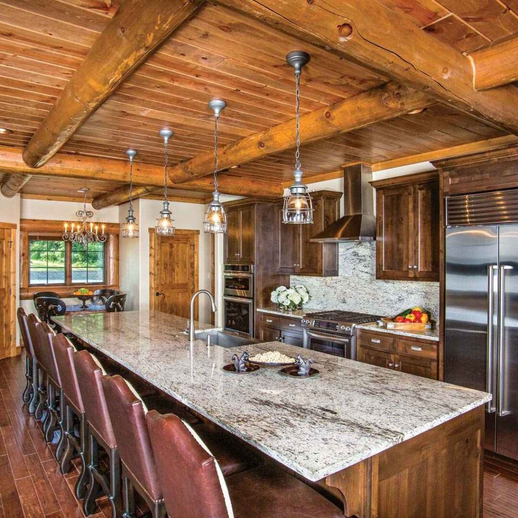 Rustic log cabin kitchen with granite island and wooden beams