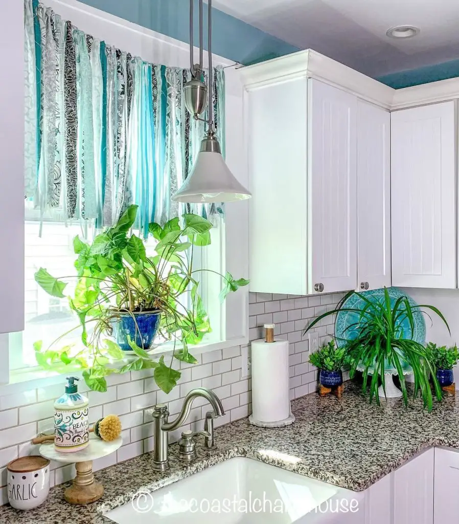 Lively kitchen with aqua ribbon valance and granite countertop