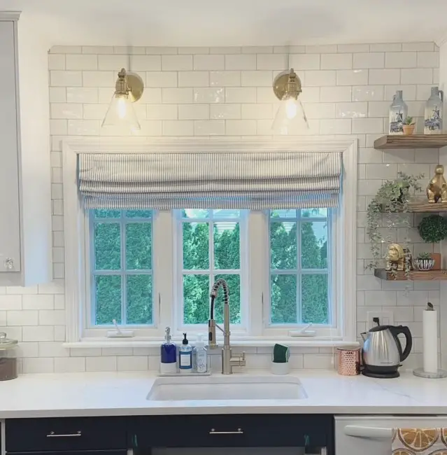 Modern kitchen with white subway tile backsplash and blue striped valance.
