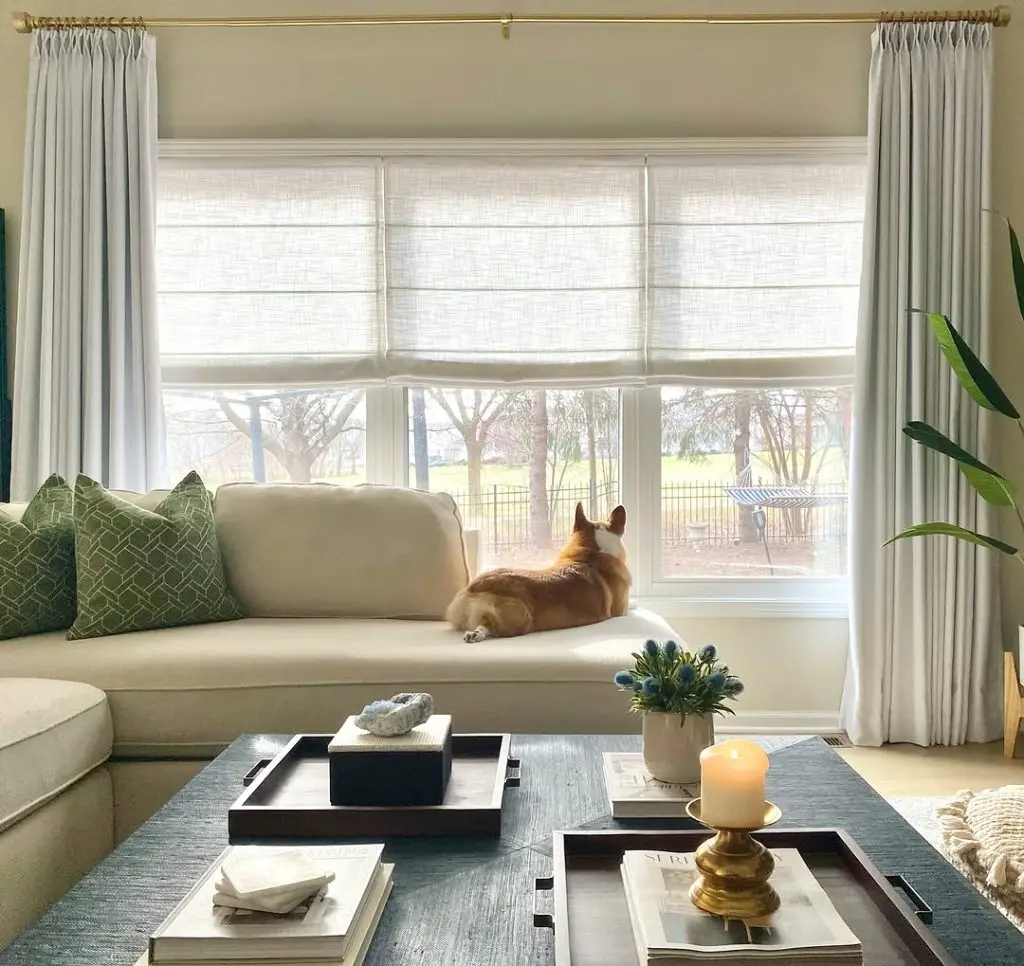 Bright living room with layered white curtains.