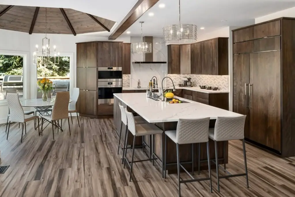 Sleek modern kitchen with wooden cabinets, marble island, and large windows