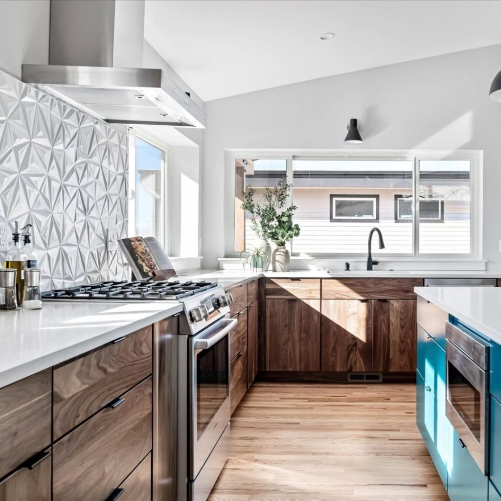 "Modern kitchen with walnut cabinets, blue island, and geometric backsplash
