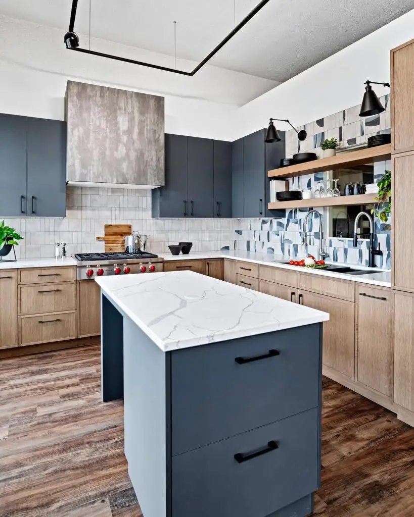 Modern kitchen with dark blue cabinets, wood accents, and a marbled island countertop