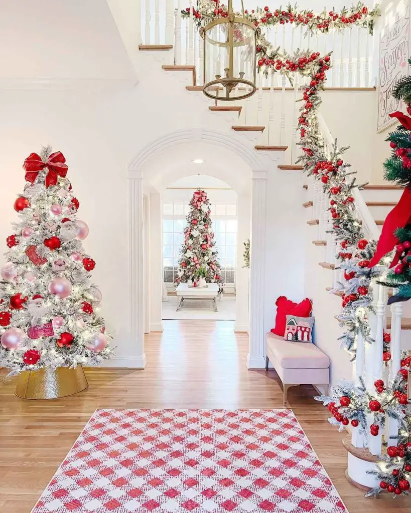 Whimsical hallway decorated for Christmas with two trees, greenery, and a patterned rug