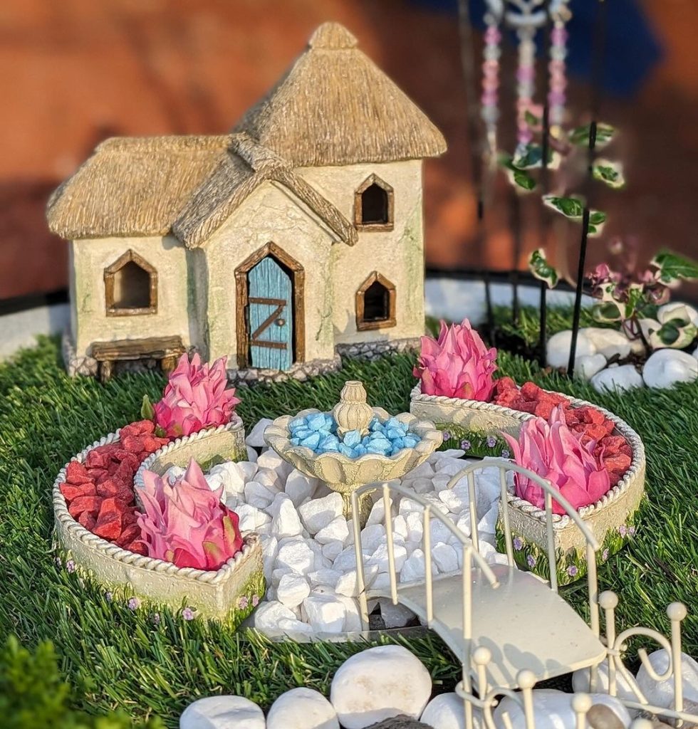 Charming garden cottage with flowers and fountain