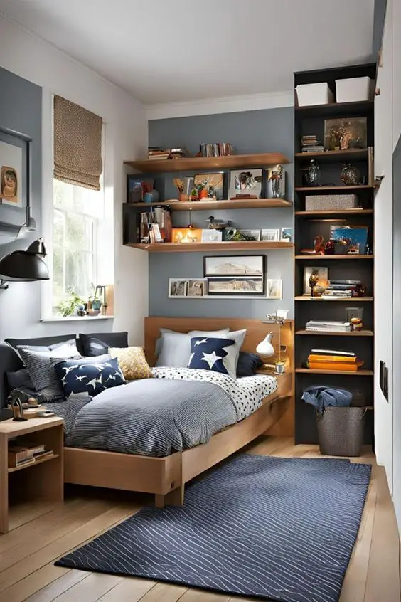 Modern teen bedroom with wooden shelves navy accent wall and bird print pillows