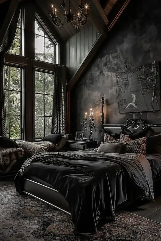 Dark bedroom with cathedral windows black bedding and vintage chandelier