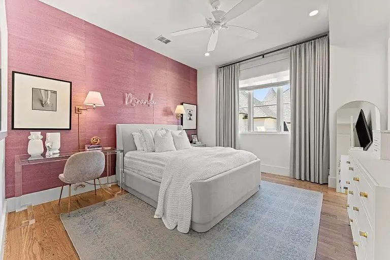 Modern bedroom with cloud shaped headboard and pink accents