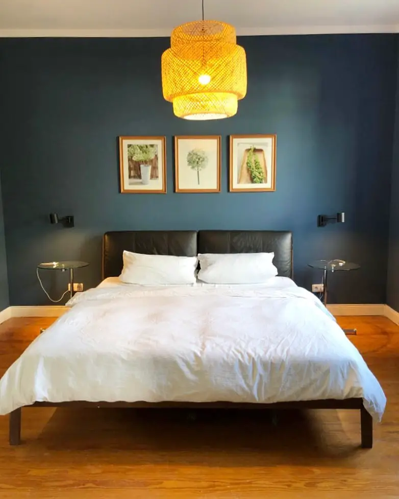 Modern bedroom with buffalo artwork floating shelves and geometric curtains