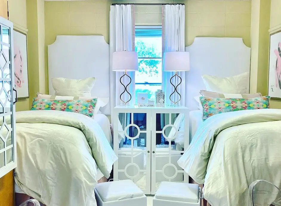 Modern dorm room with string lights vintage rug and white bedding