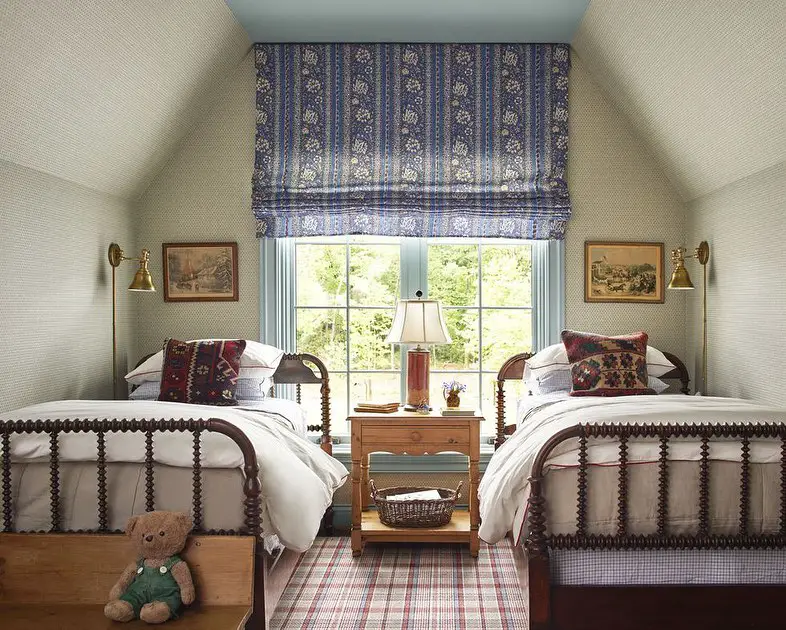 Twin bedroom with spindle beds floral shade and plaid carpet
