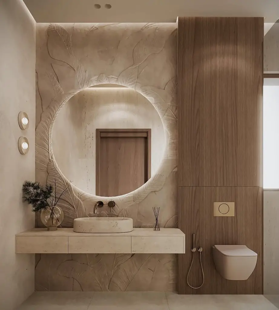 Beige bathroom with carved leaf pattern wall and round mirror