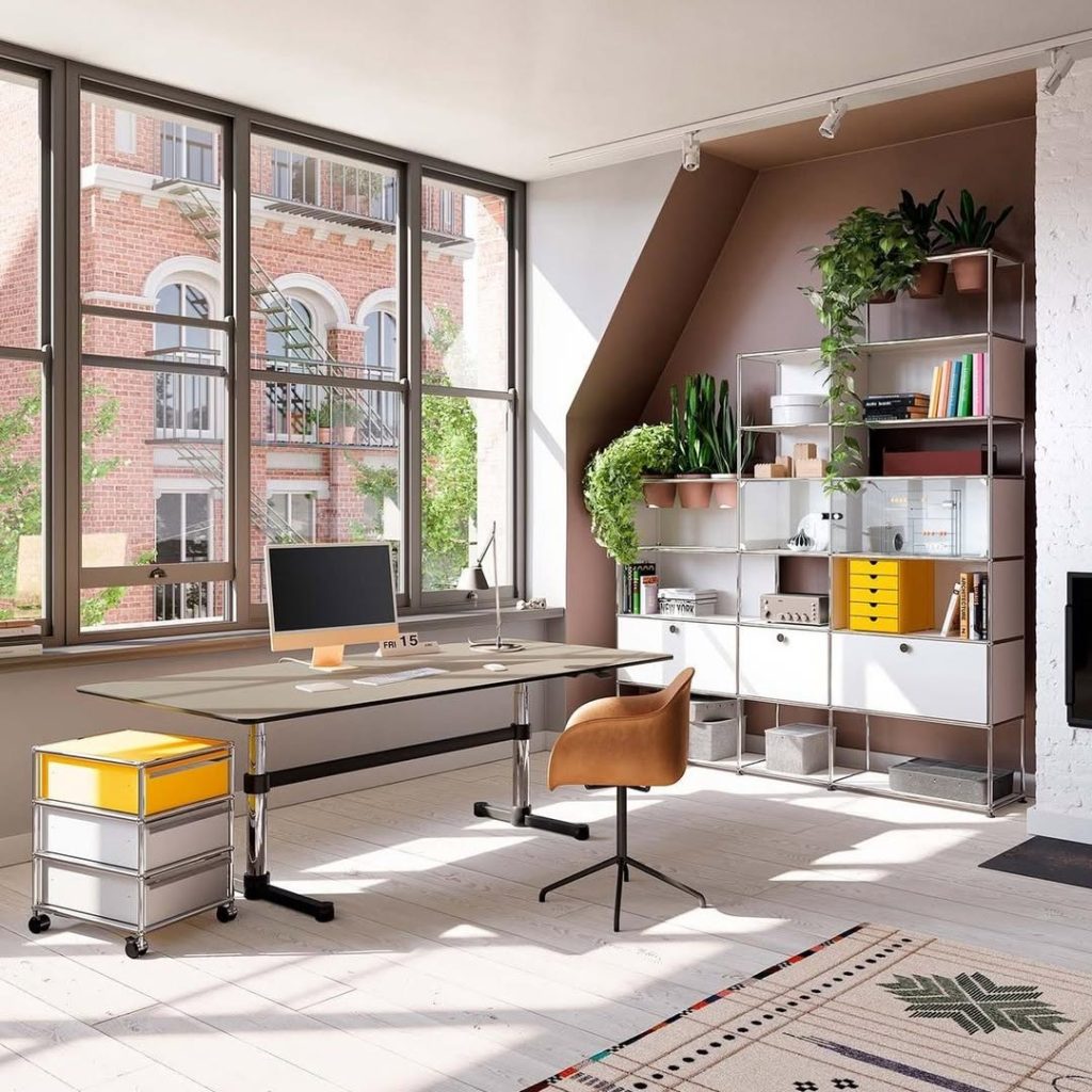 Home office with dark green built in shelves and modern desk