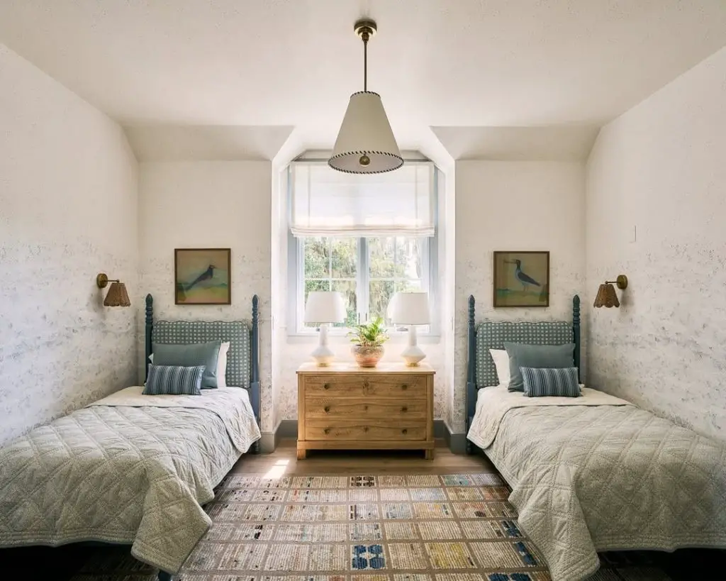 Twin bedroom with blue headboards bird prints and quilted bedding