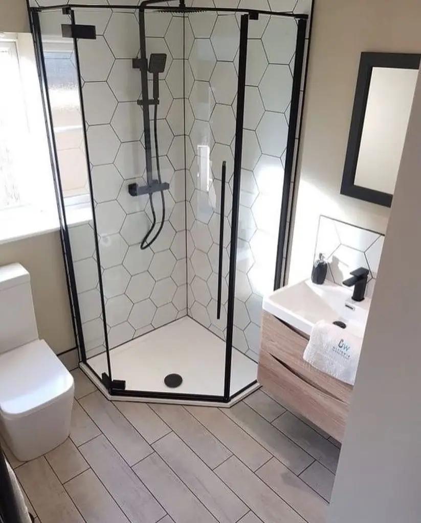 Bathroom with chevron marble tiles brass fixtures and round mirrors
