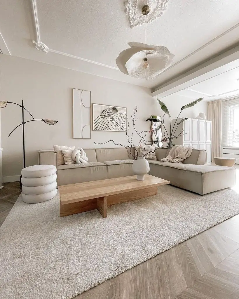 Neutral living room with sectional sofa and botanical wall prints