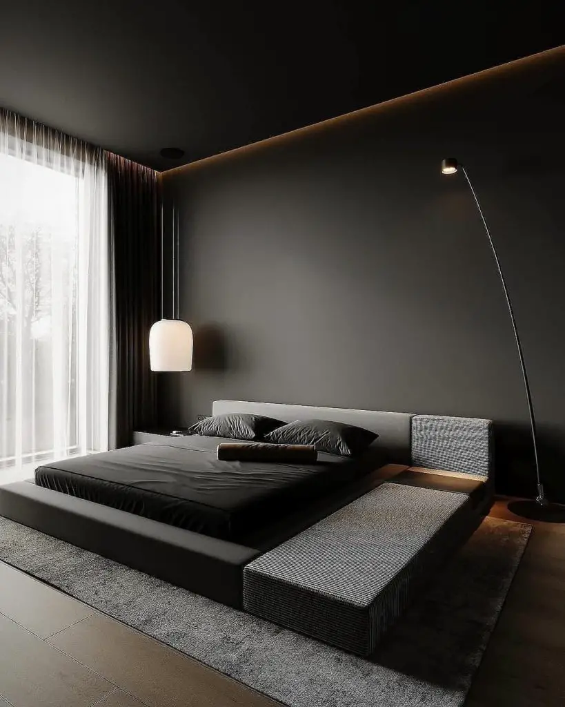 Dark minimalist bedroom with platform bed and modern lighting