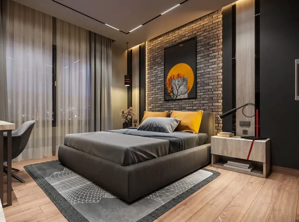 Modern bedroom with brick wall and sunset artwork above be