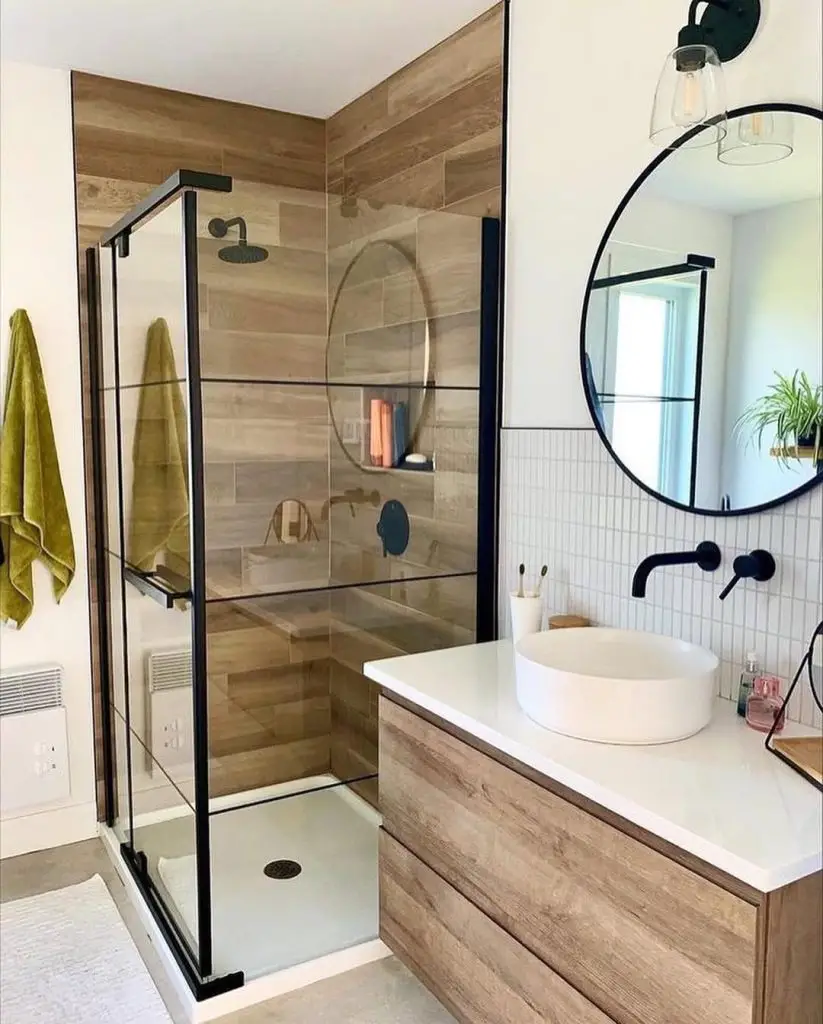 Modern bathroom with hexagon tiles black frame shower and wooden floor