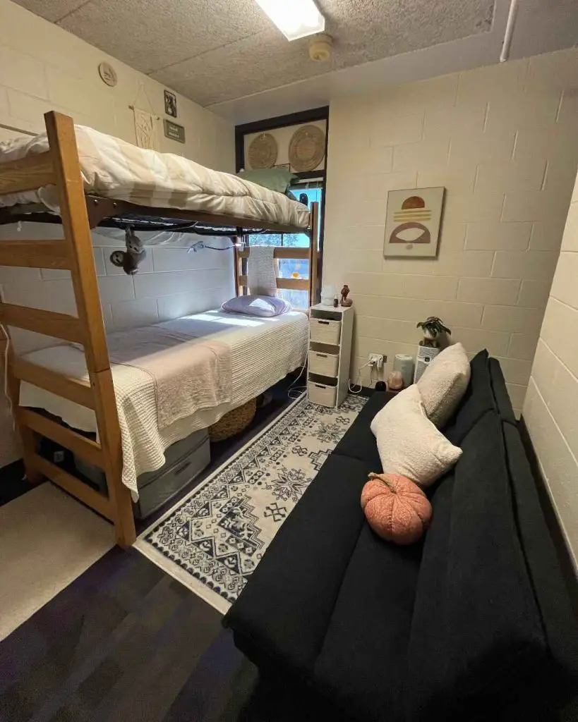 Twin dorm room with animal prints green bedding and wooden beds