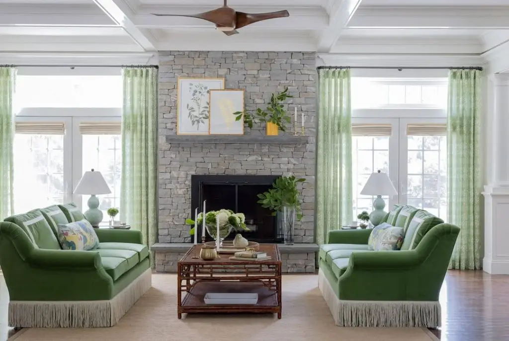 Modern living room with black walls emerald sofa and city views