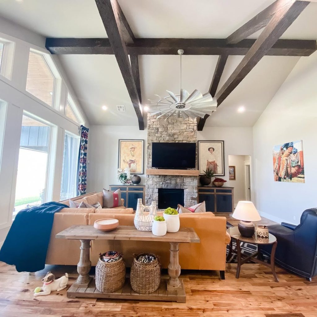 Ranch style library with stone fireplace built in shelving and comfortable seating