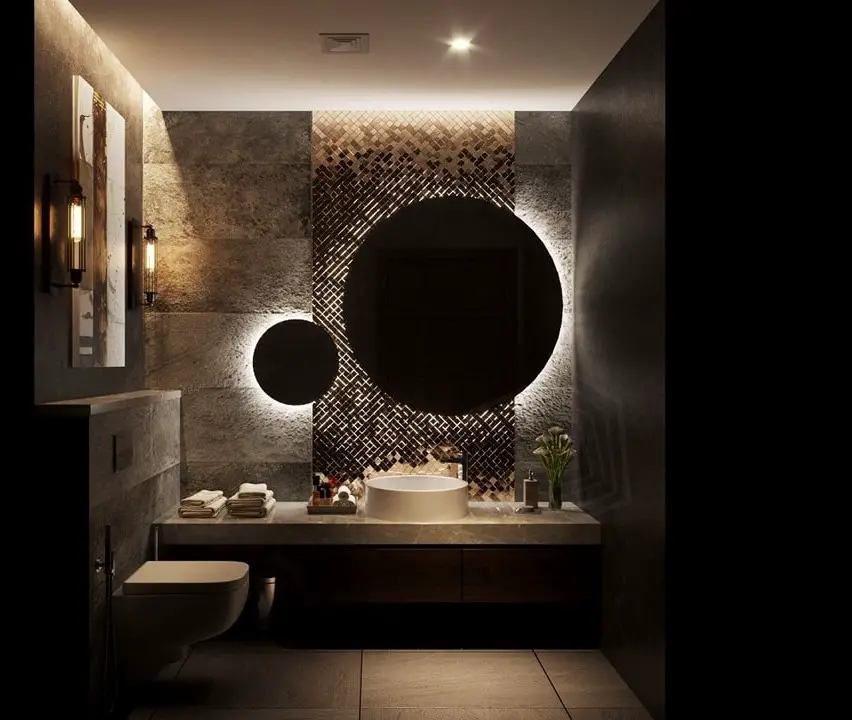 Dark modern bathroom with geometric tile and illuminated round mirrors