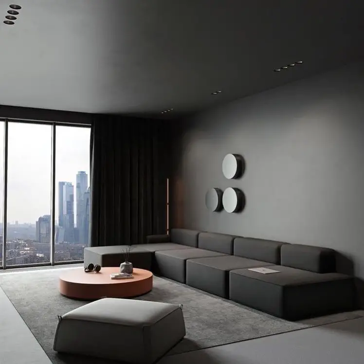 Modern gray living room with circular wall decor and city views
