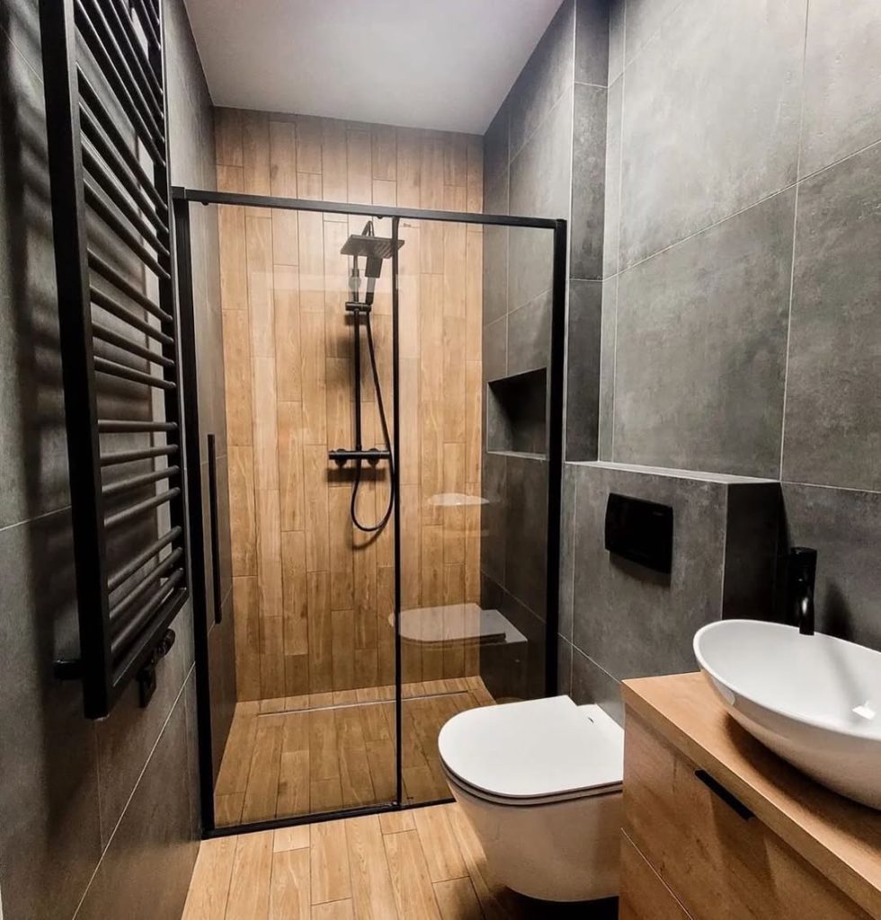 Minimalist bathroom with wooden accents black shower frame and modern sink