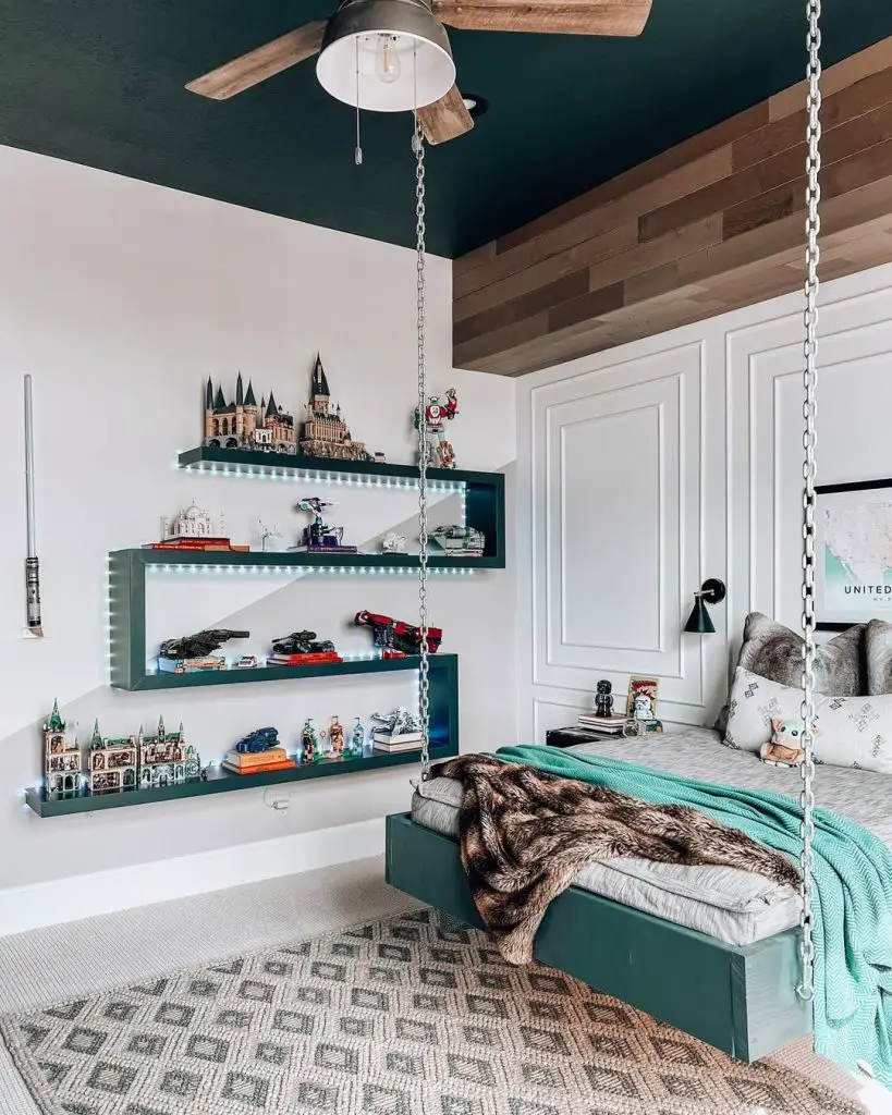 Themed bedroom with illuminated shelving displaying castle models