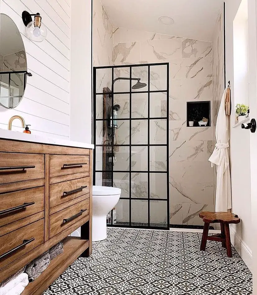 Modern bathroom with patterned floor wooden vanity and white walls