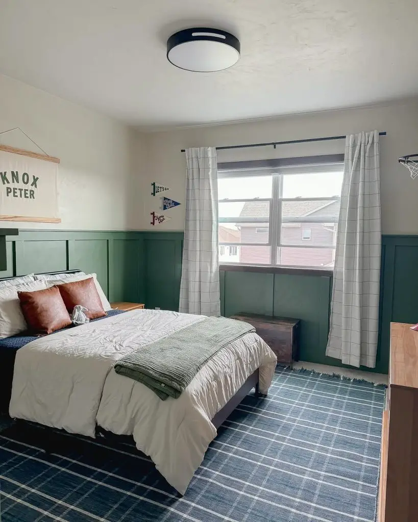 Modern bedroom with green wainscoting white bedding and plaid rug