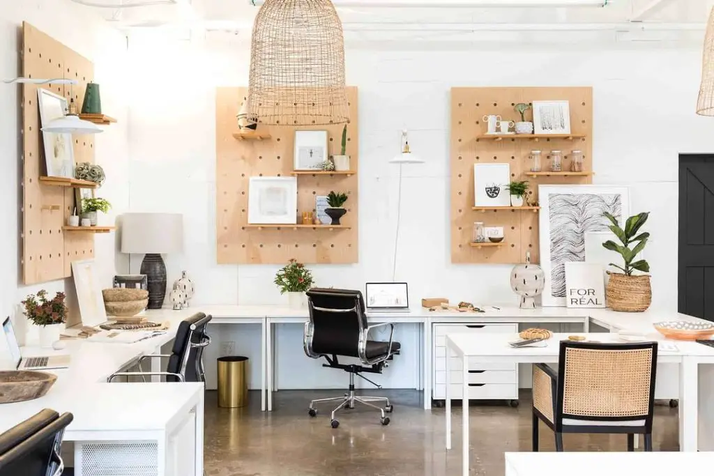 Modern home office with geometric shelving and white desks