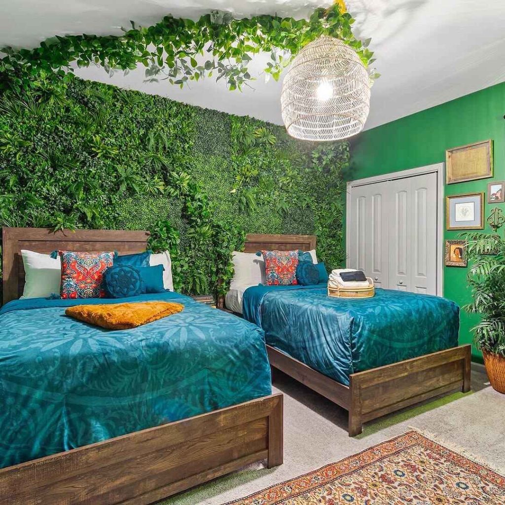 Double bedroom with green living wall and teal bedding accents
