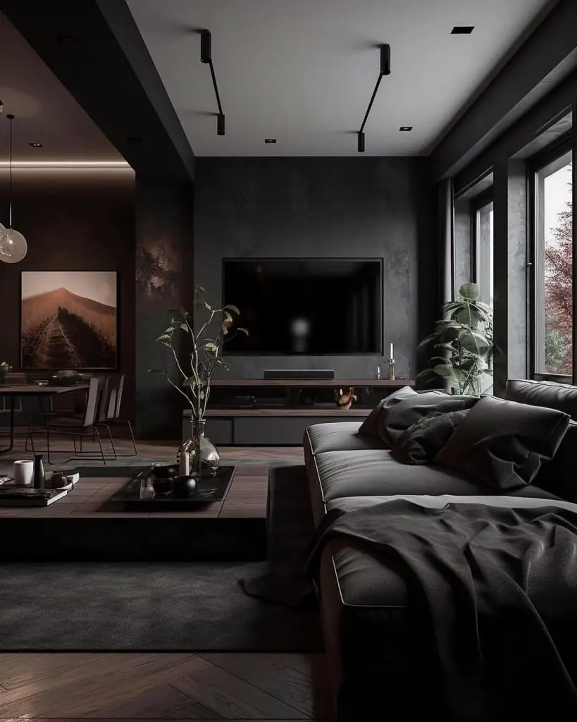 Dark modern living room with gray sectional and landscape art