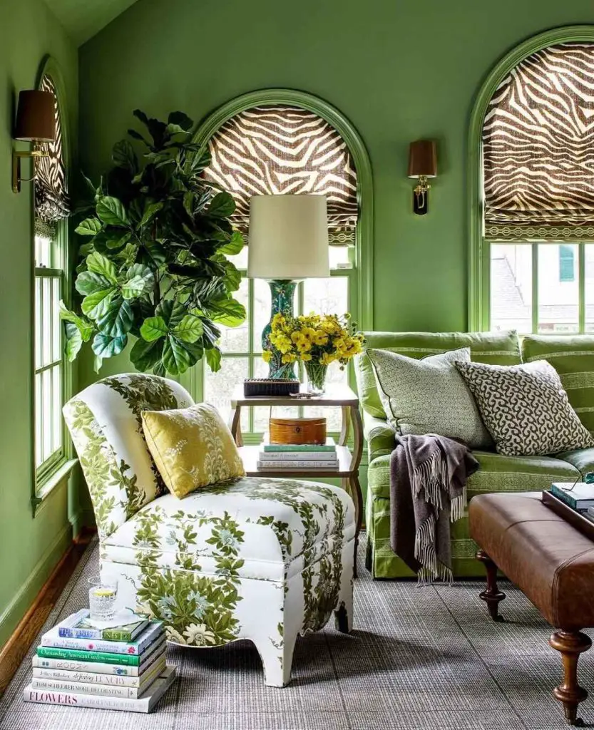 Dark green living room with velvet sofa forest artwork and hanging plants