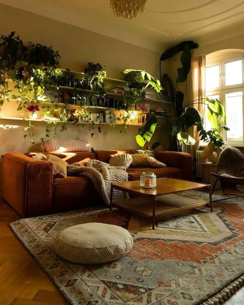 Living room with hanging plants books and brown leather couch