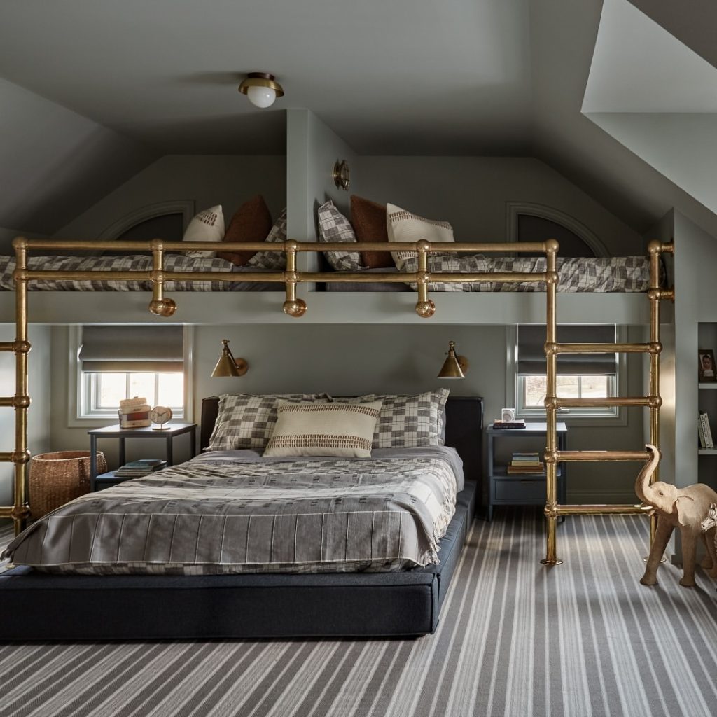 Modern bedroom with brass pipe loft and striped carpet