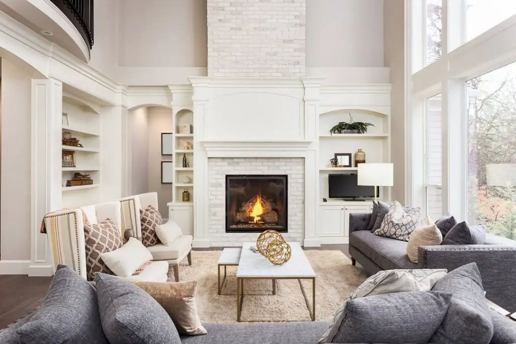 Living room with high ceilings stone fireplace and traditional furniture arrangement
