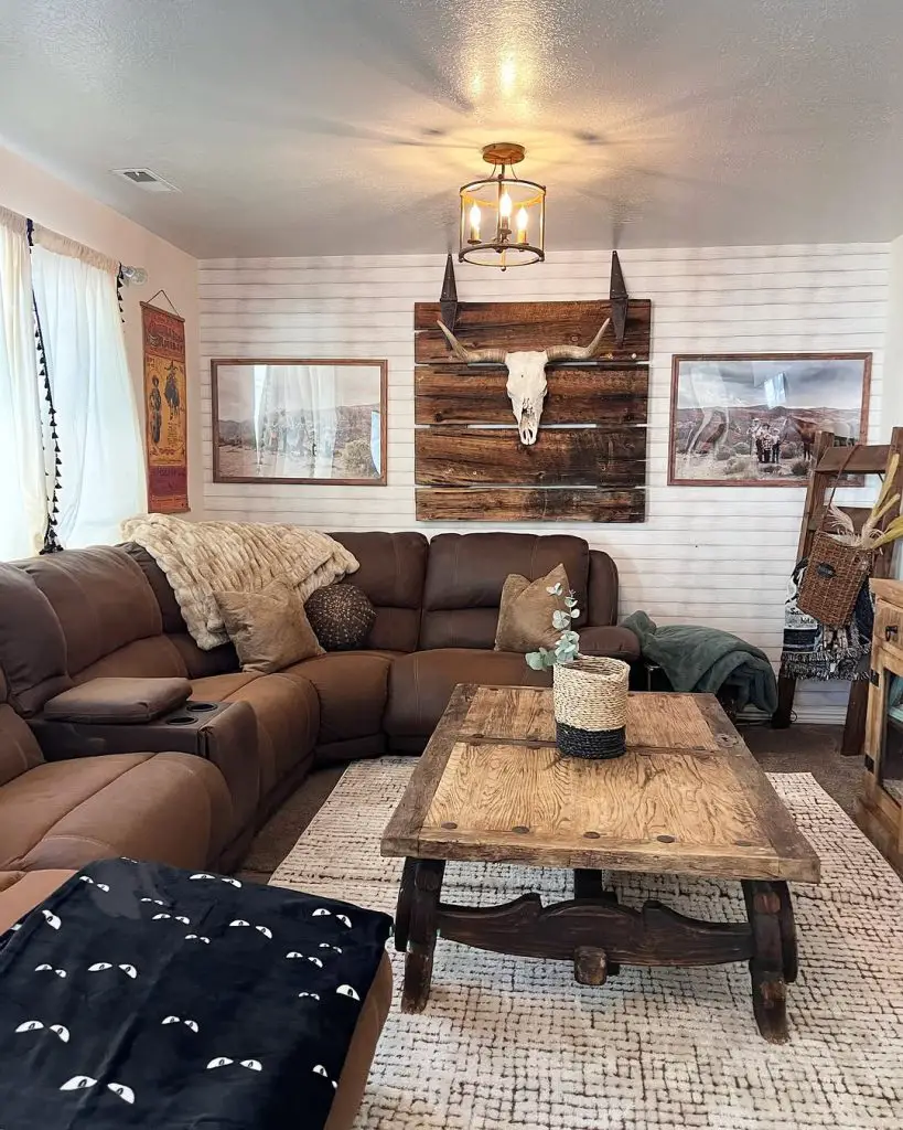 Western style living room with shiplap walls leather sectional and rustic decor