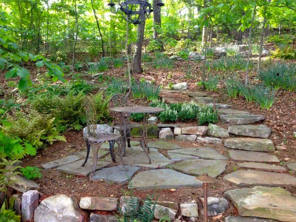 Stone garden path lined with ornamental grasses and flowering plants